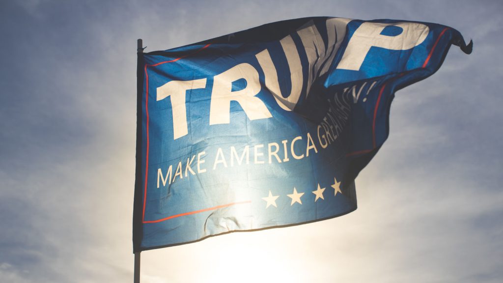 Flag with the words "Trump: Make America Great Again" blows in the wind.