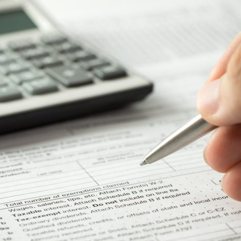 US individual income tax return form with pen and calculator
