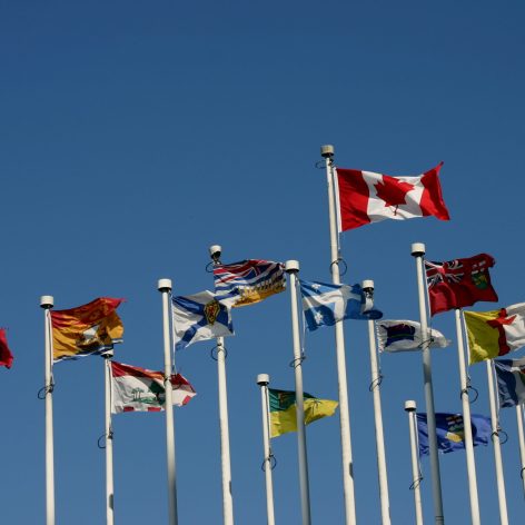 "All the flags of Canada including the provinces and territories blowing proudly in the wind at Canada Place in Vancouver, B.C. Canada"
